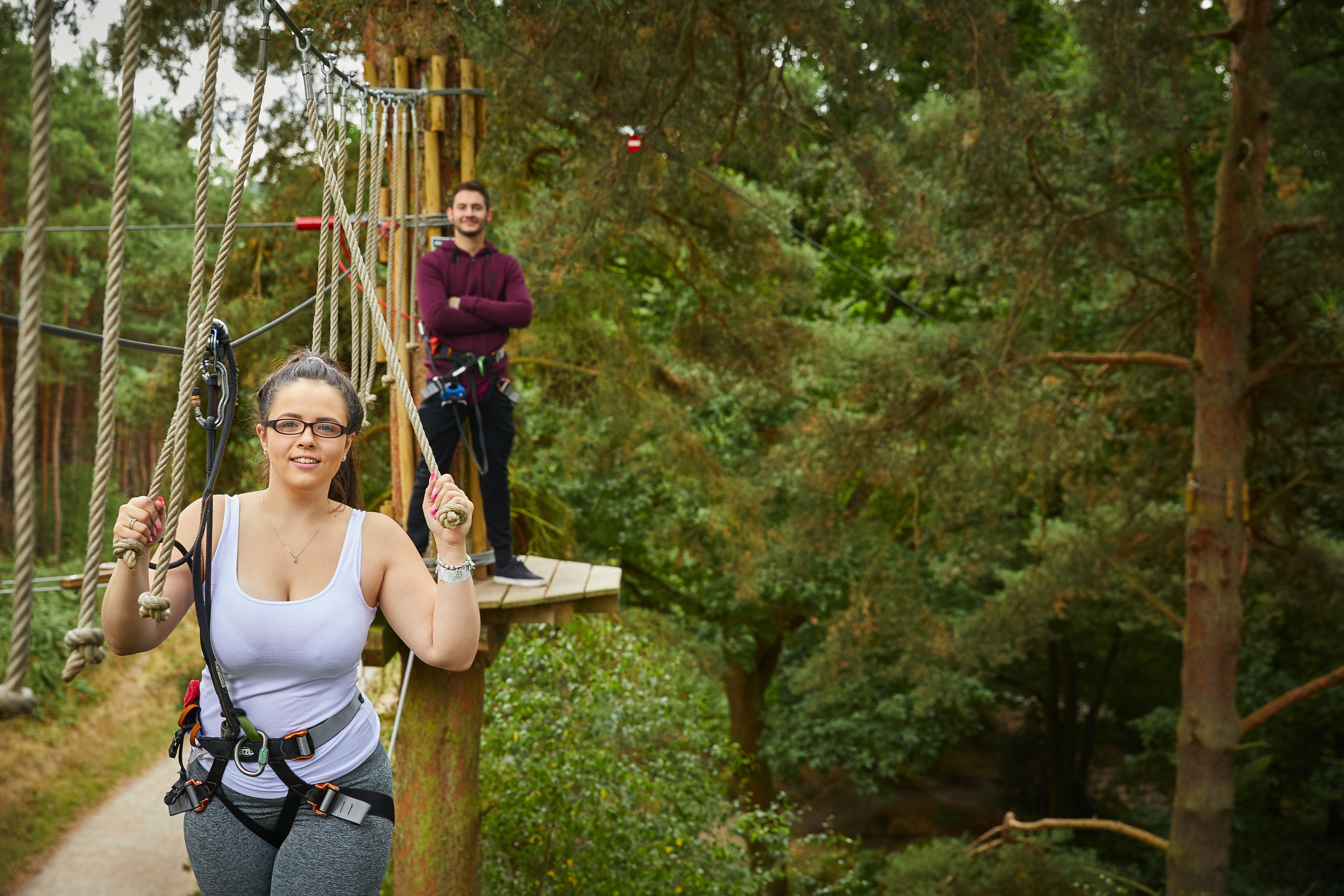 Two people on a high ropes course.