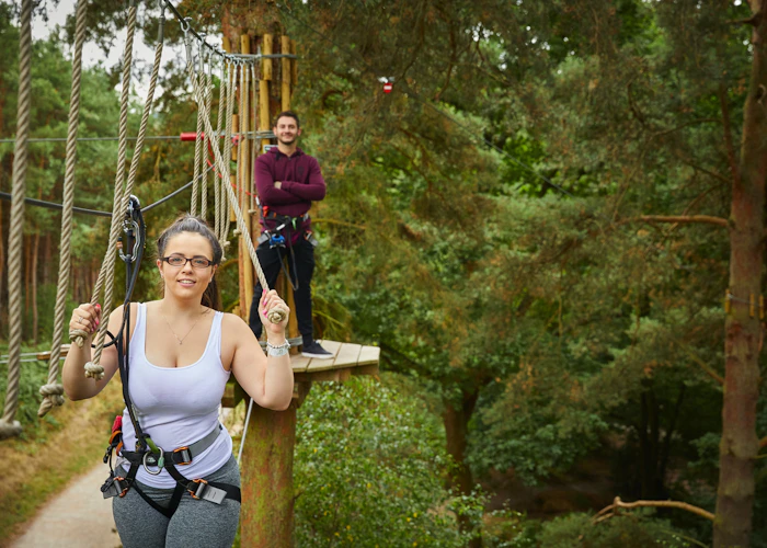Two people on a high ropes course.