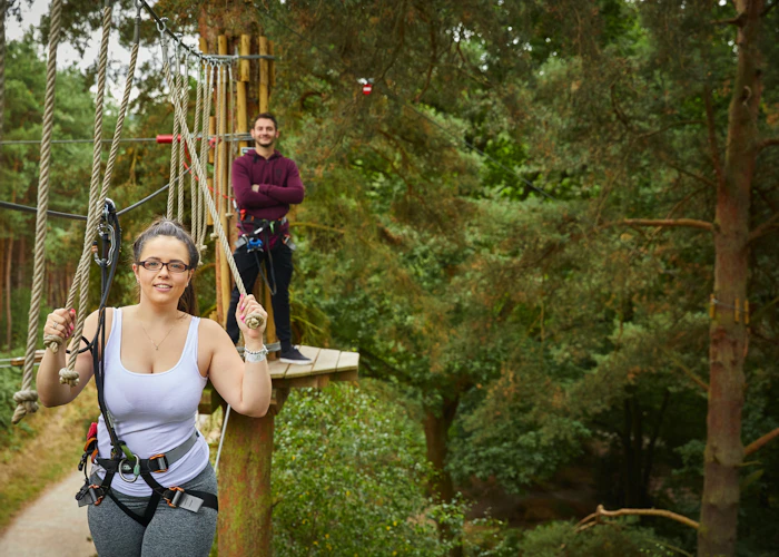 Two people on a high ropes course.