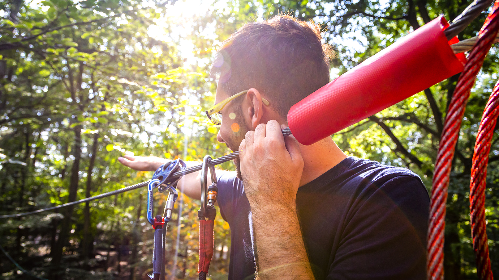 Close up of a person on a high ropes course.