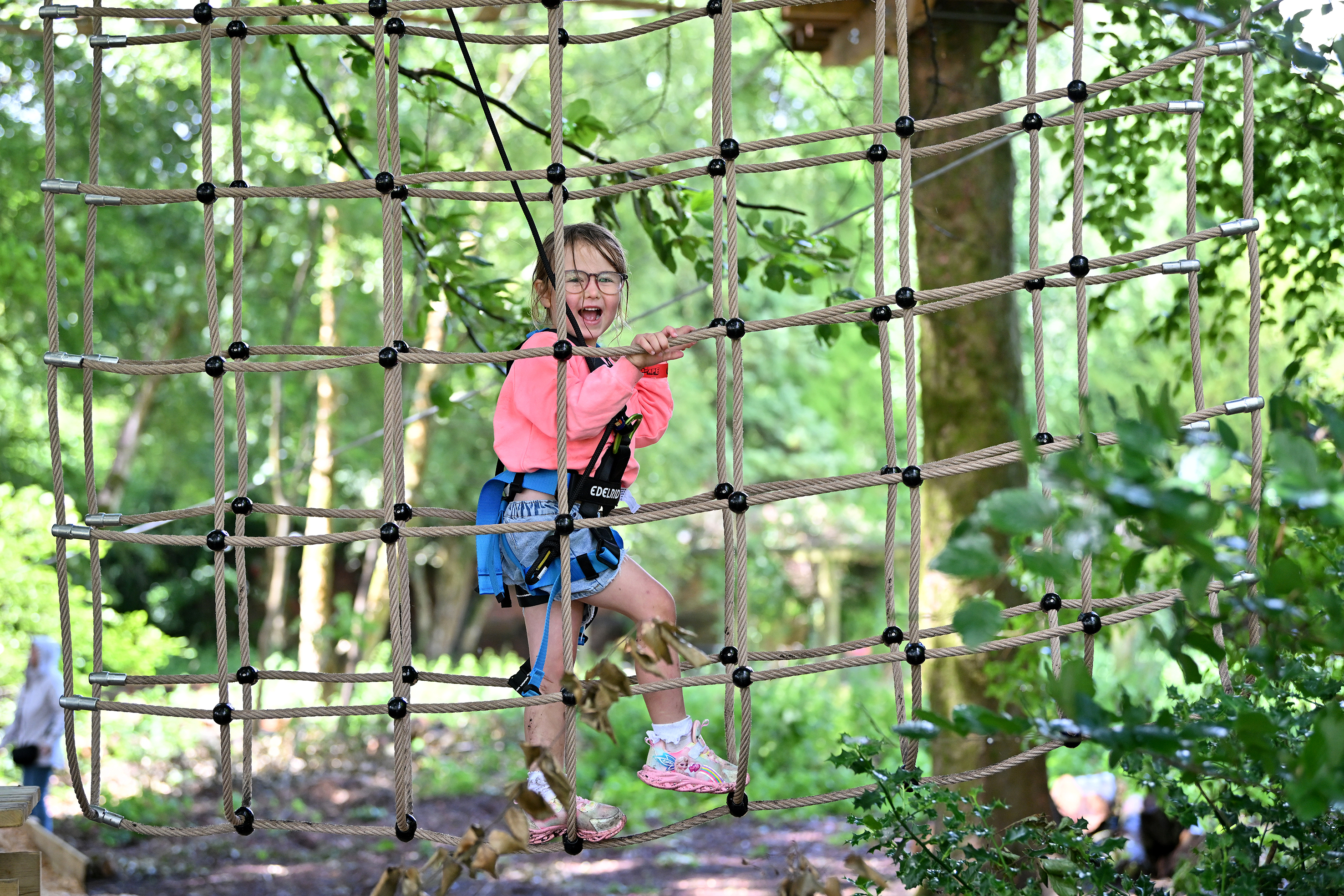 Young person on a high ropes course.