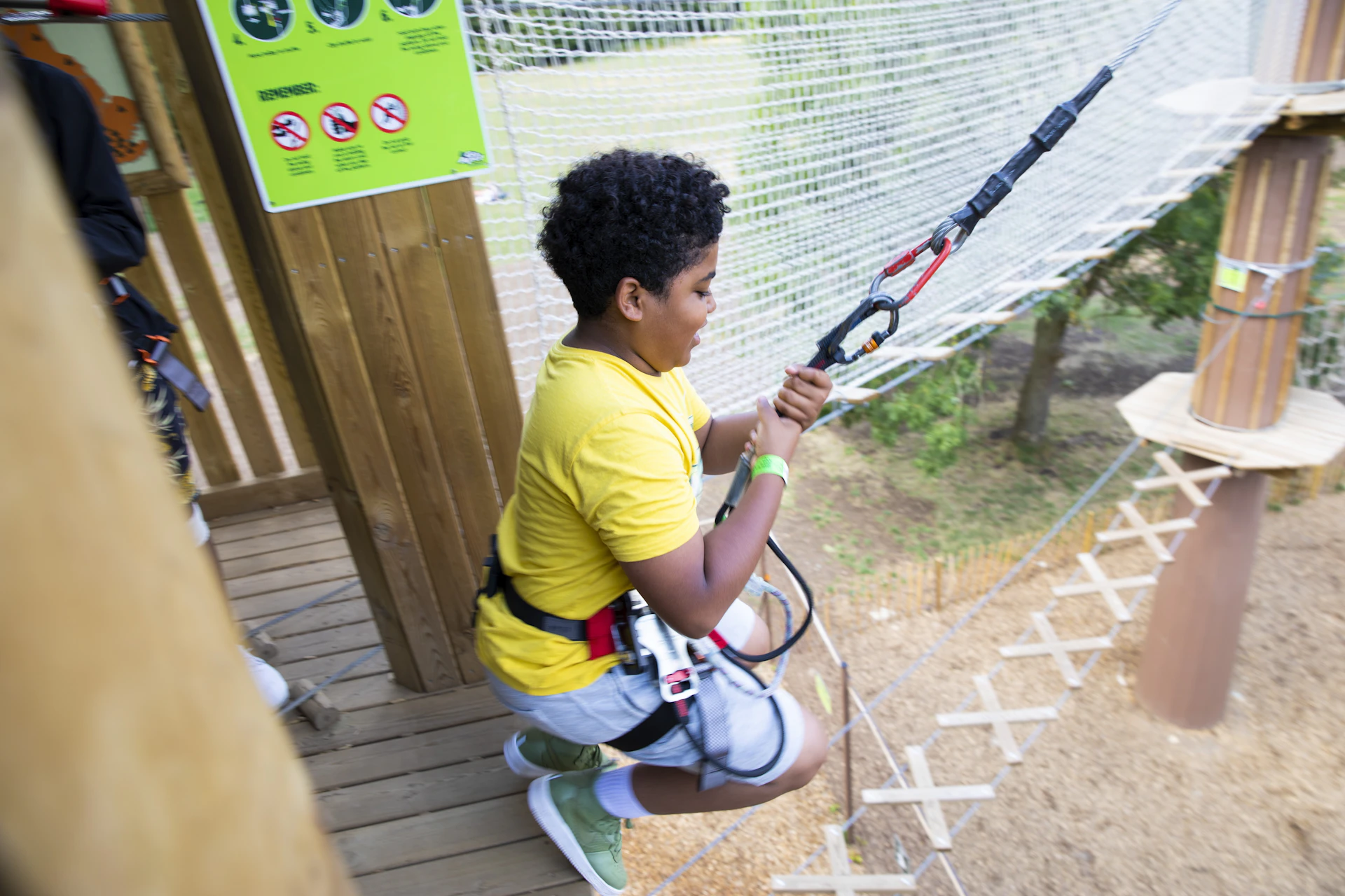 Young person on a high ropes course.