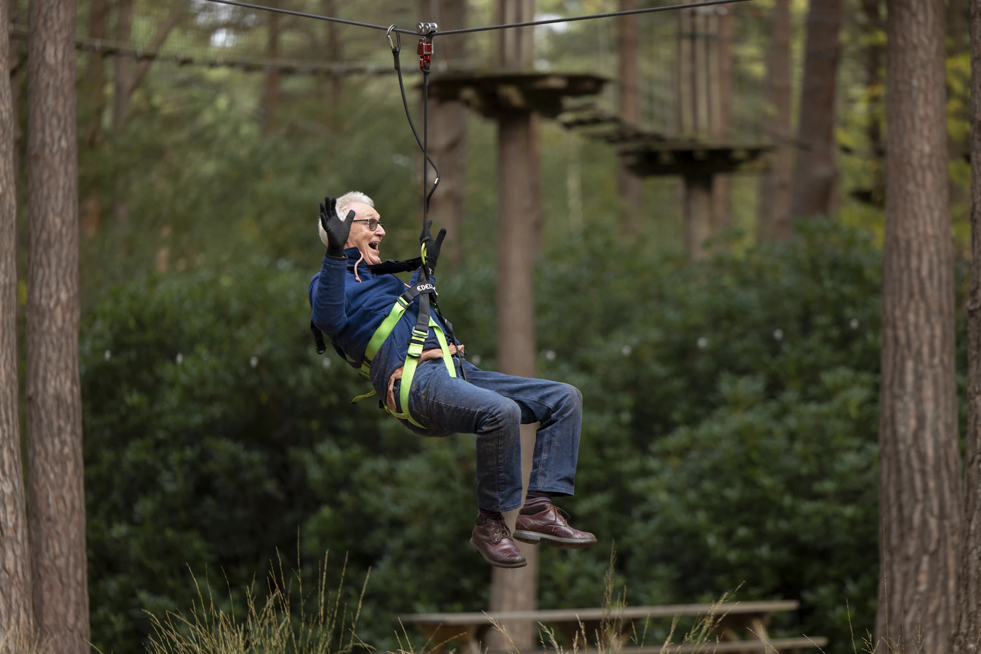 Person on a zipline while smiling.