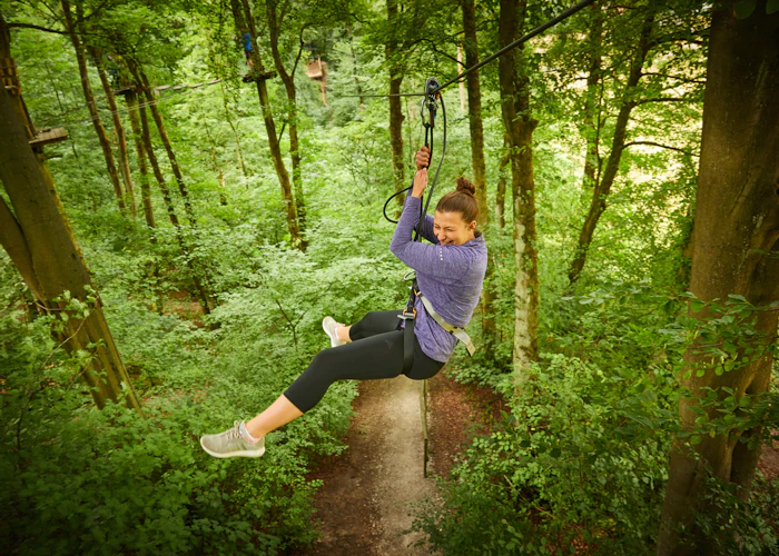 Person on a zipline while smiling.