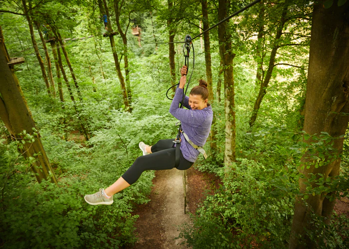 Person on a zipline while smiling.