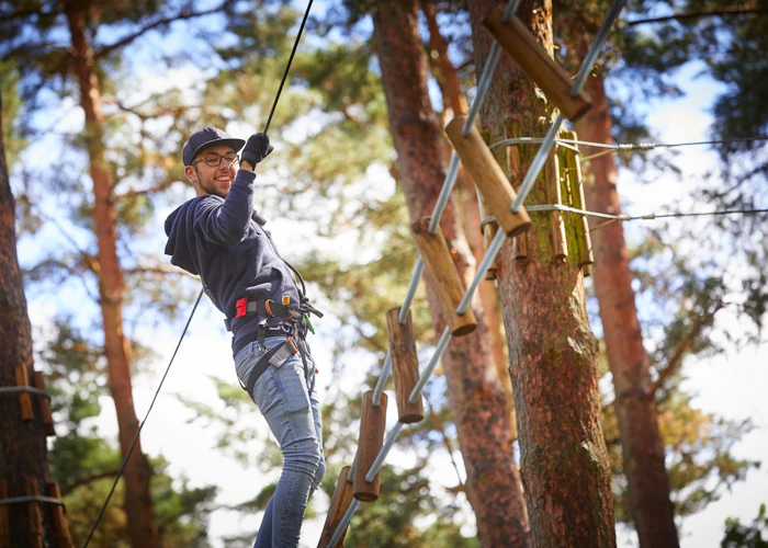 Person on a high ropes course.