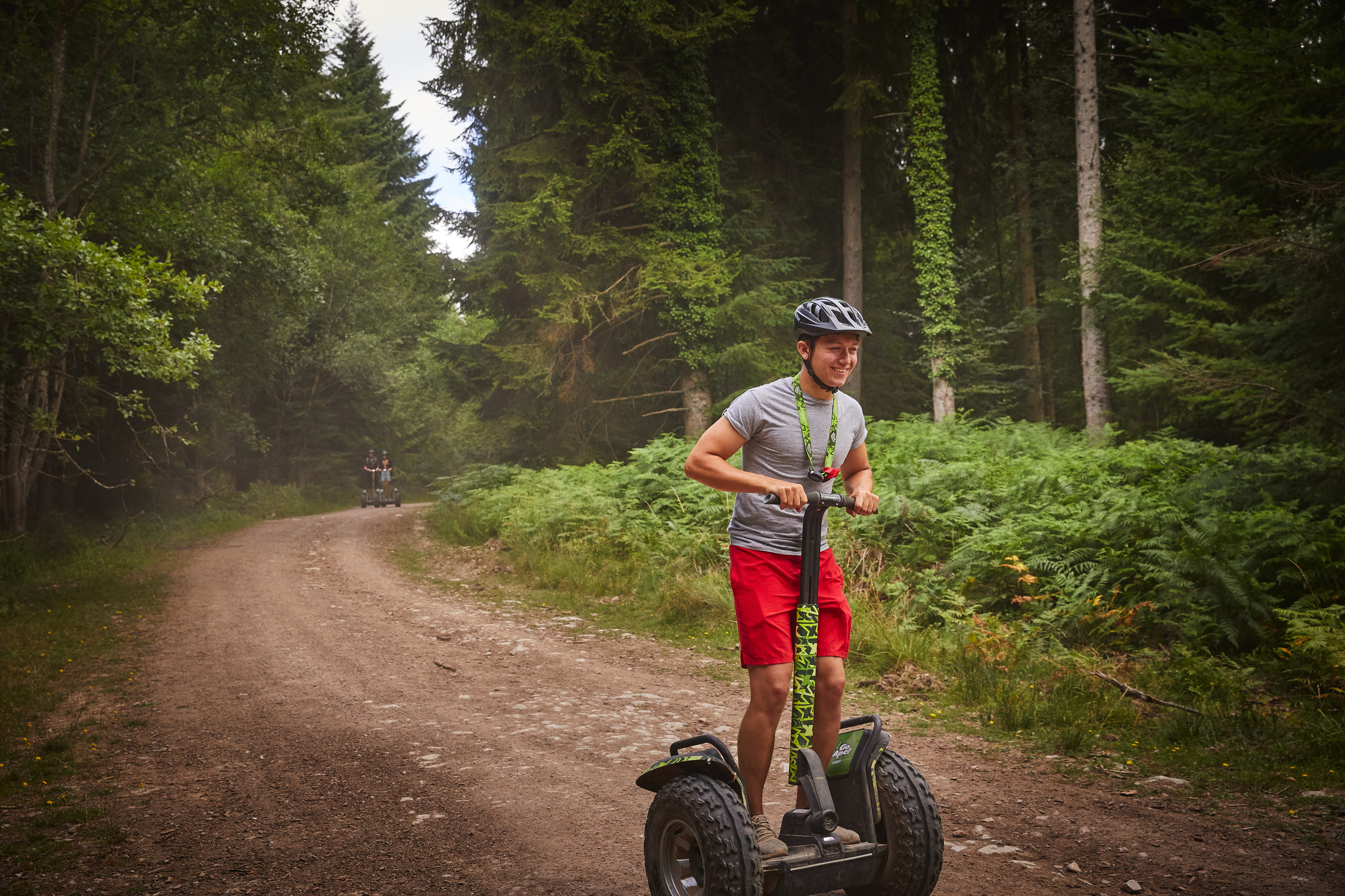 Person on a Segway on a forest trail.