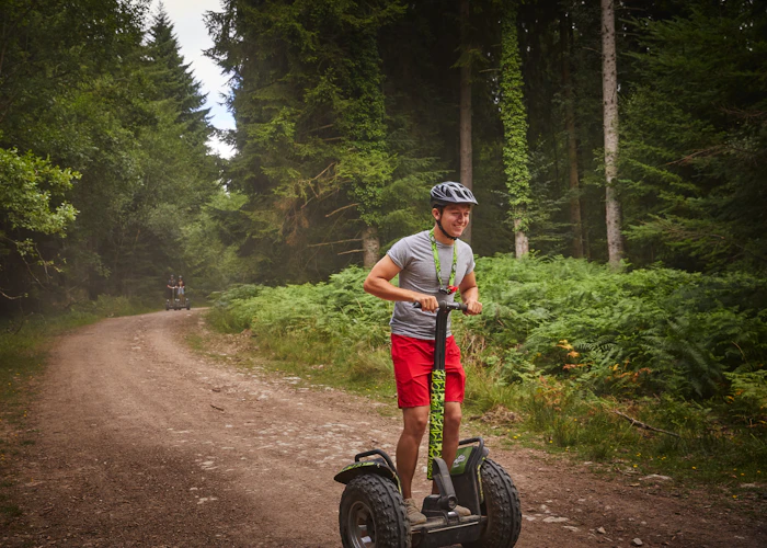 Person on a Segway on a forest trail.