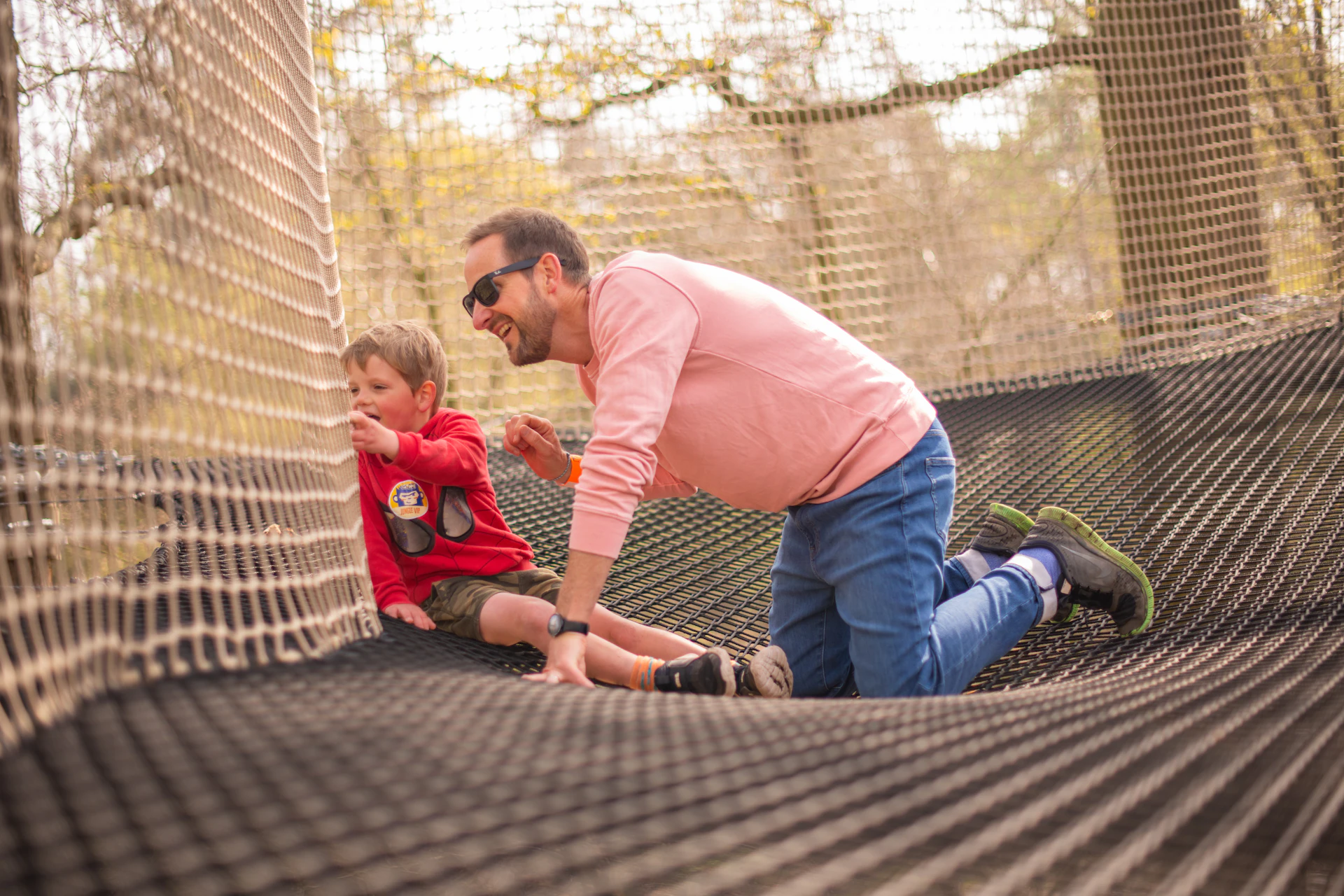 A boy and his dad take int he view from a Go Ape Nets Adventure course