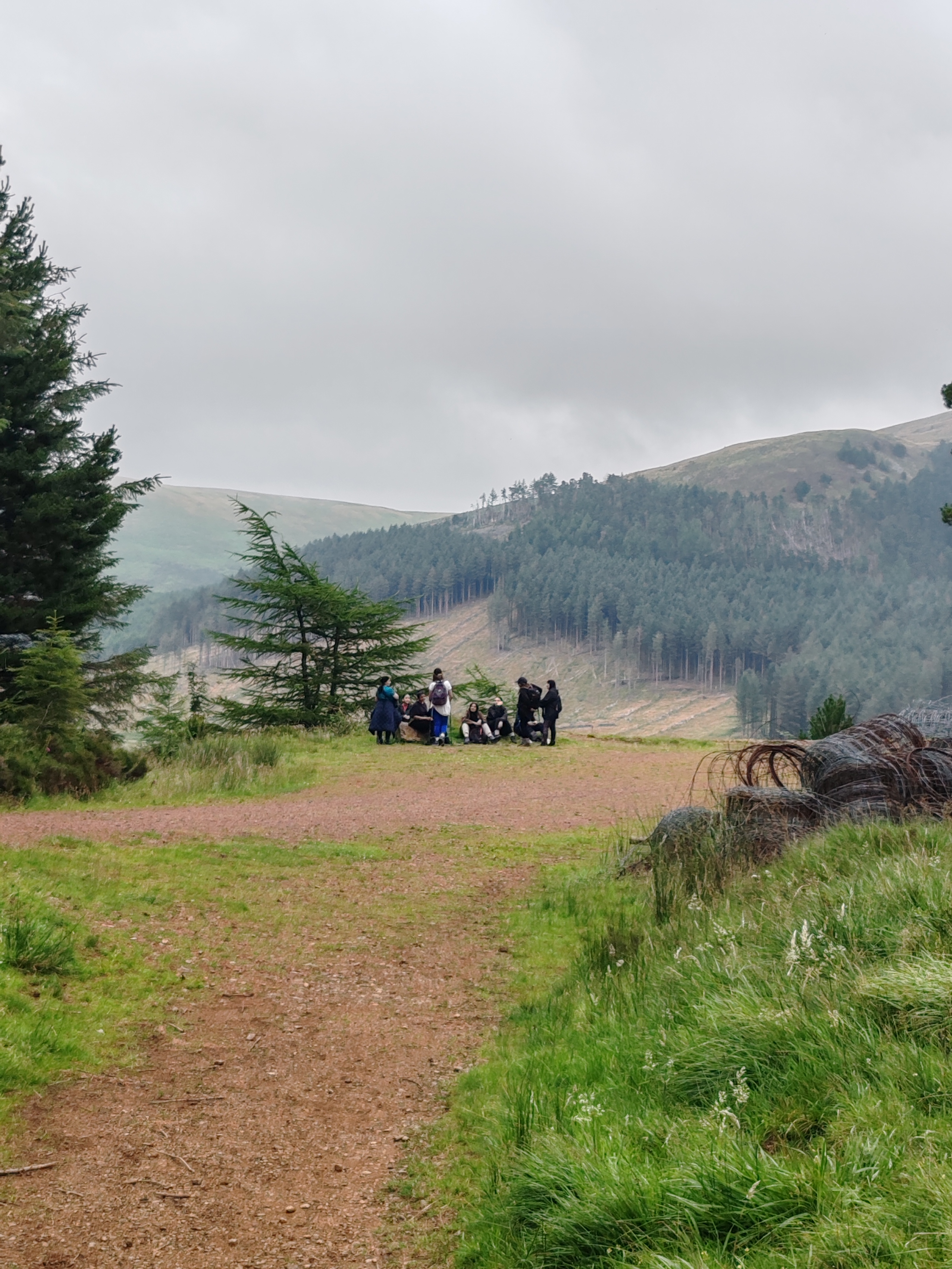 Walking group in the distance around beautiful hills.