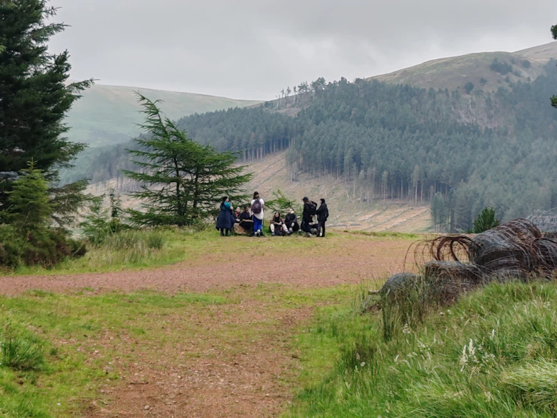 AdventureMind Grant 2025 Walking group in the distance around beautiful hills.