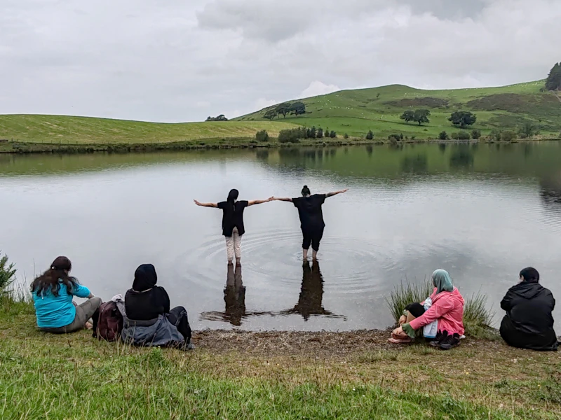 AdventureMind Grant 2025 People resting by a lake and paddling.