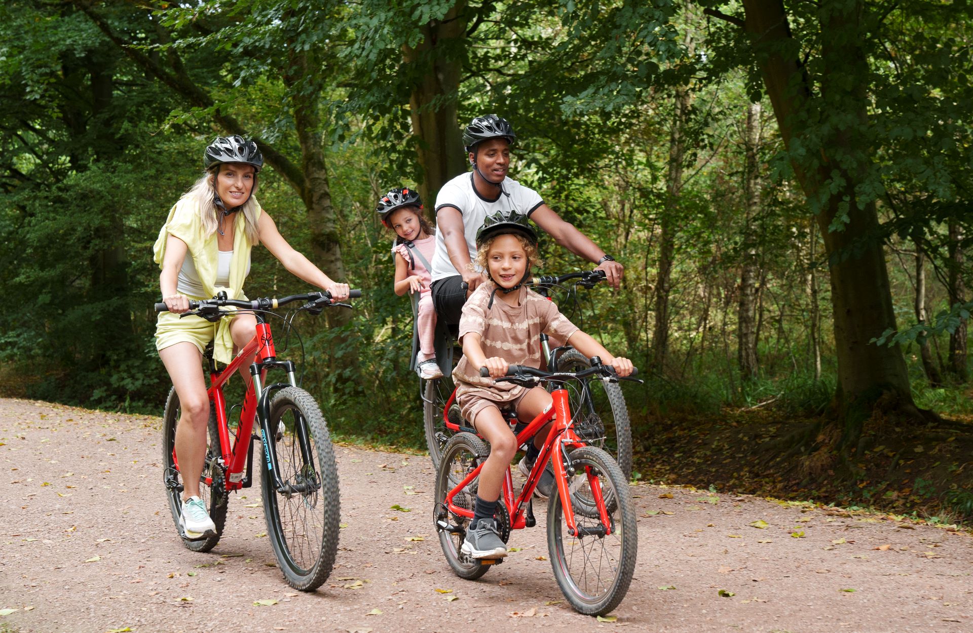 A family enjoy a bike ride in the forest