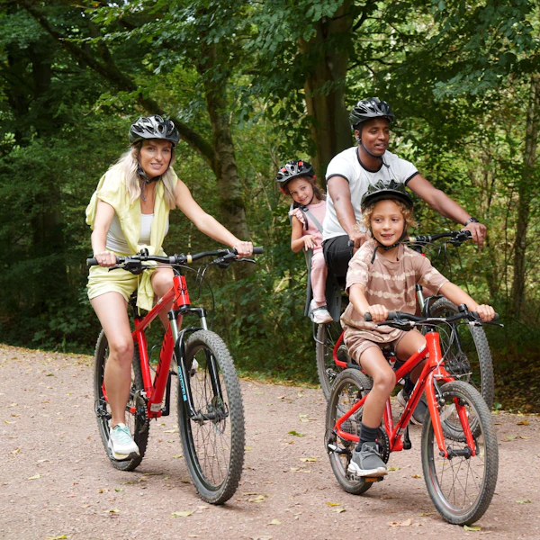 A family enjoy a bike ride in the forest