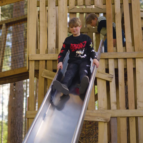 A child rides a slide in the playground