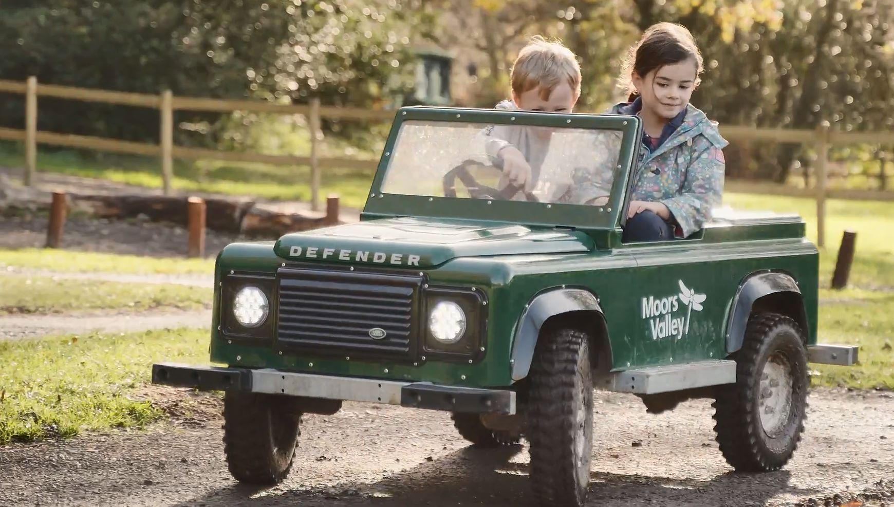 Children ride a Mini Land Rover