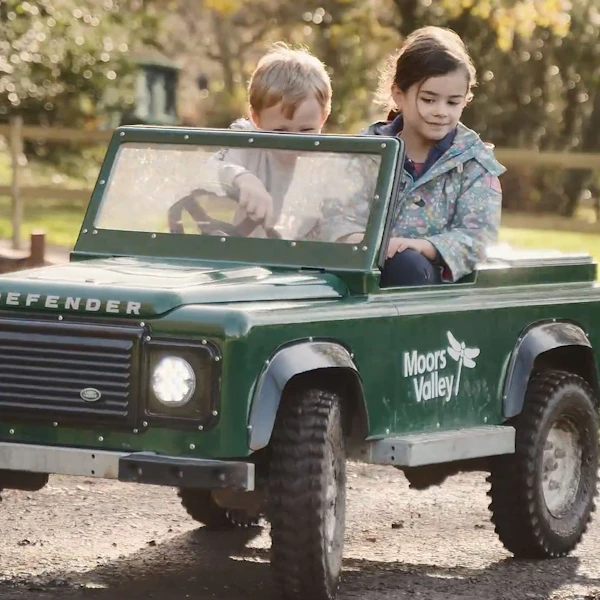 Children ride a Mini Land Rover