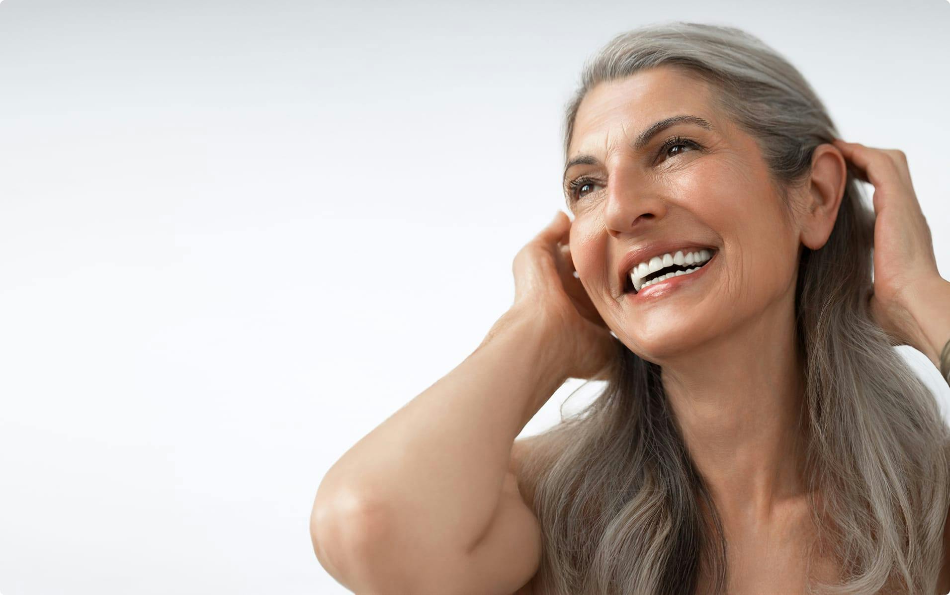 Woman with gray hair, smiling