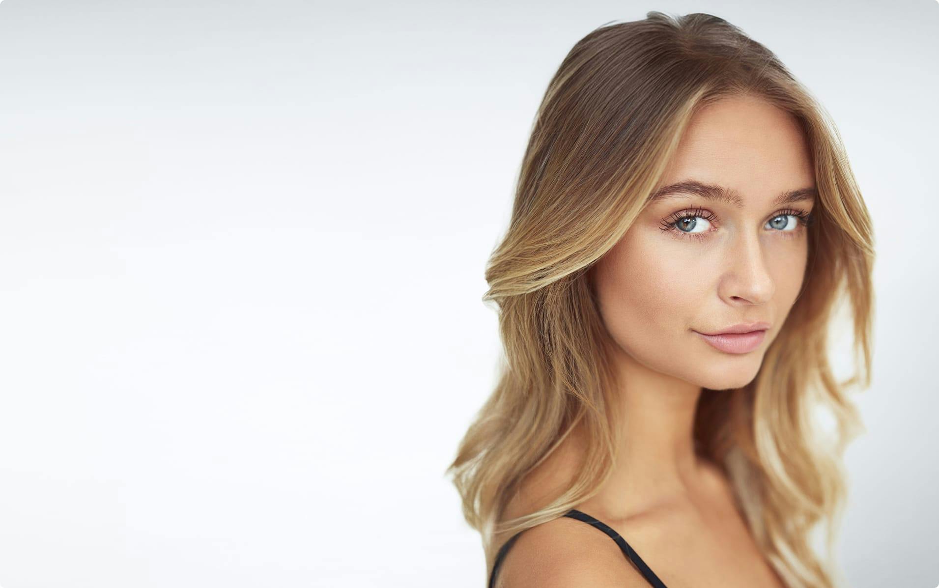 Woman with blond hair giving a sidelong glance