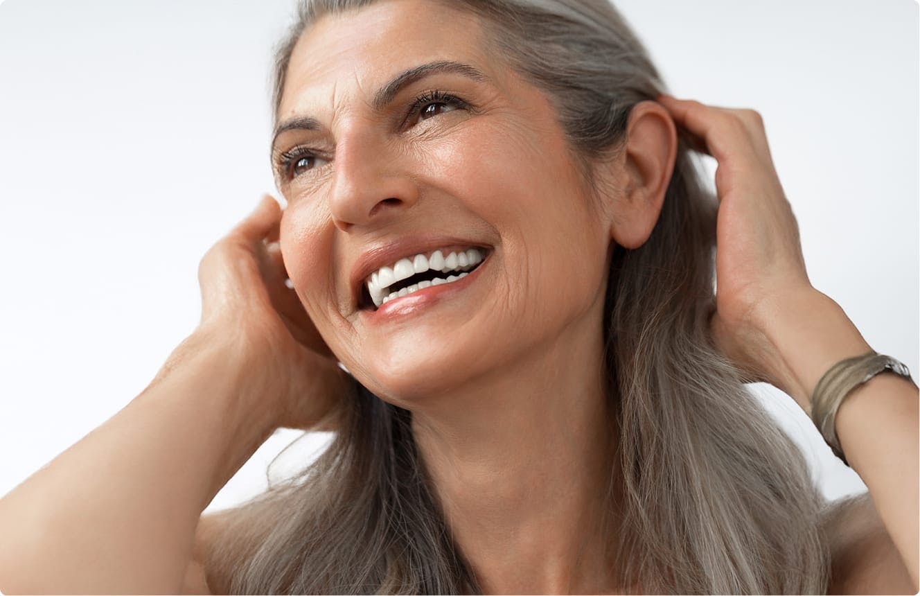 Woman with gray hair, smiling