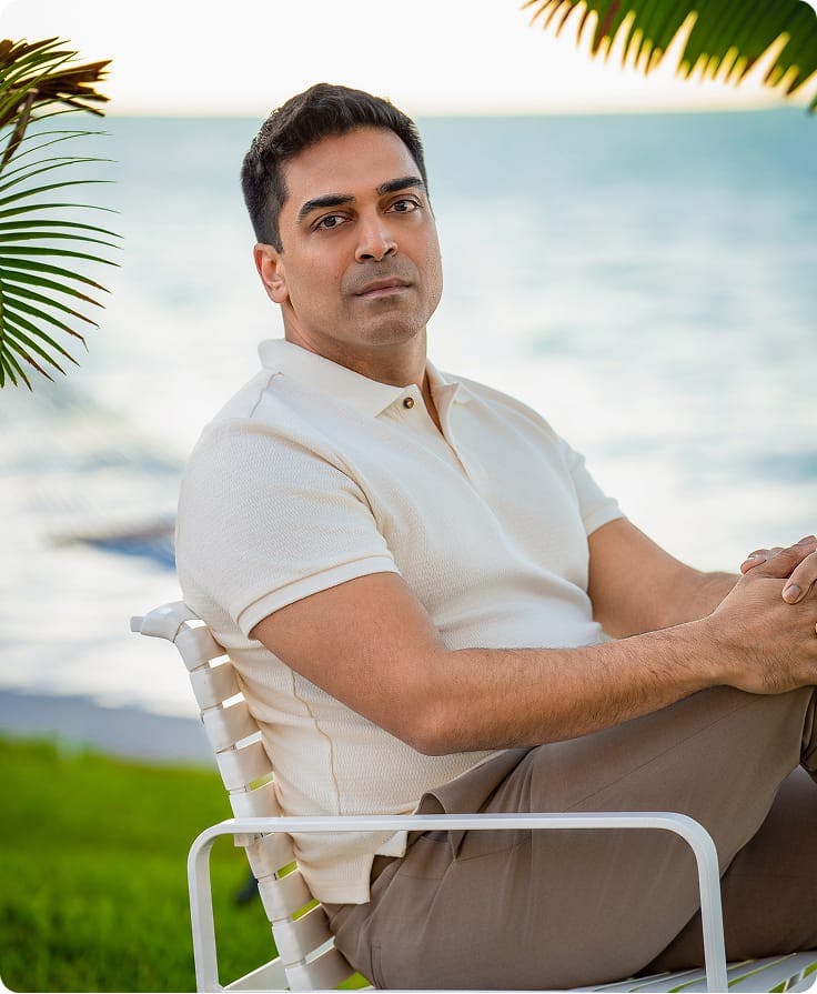 Dr. Nathan in a chair by the ocean