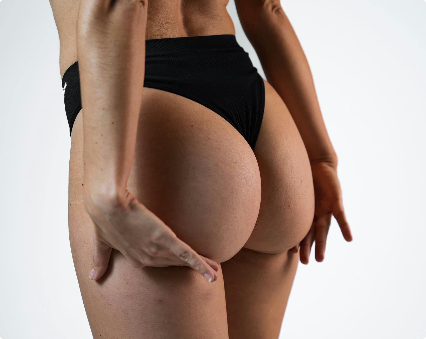 woman lifting her buttocks with her hands