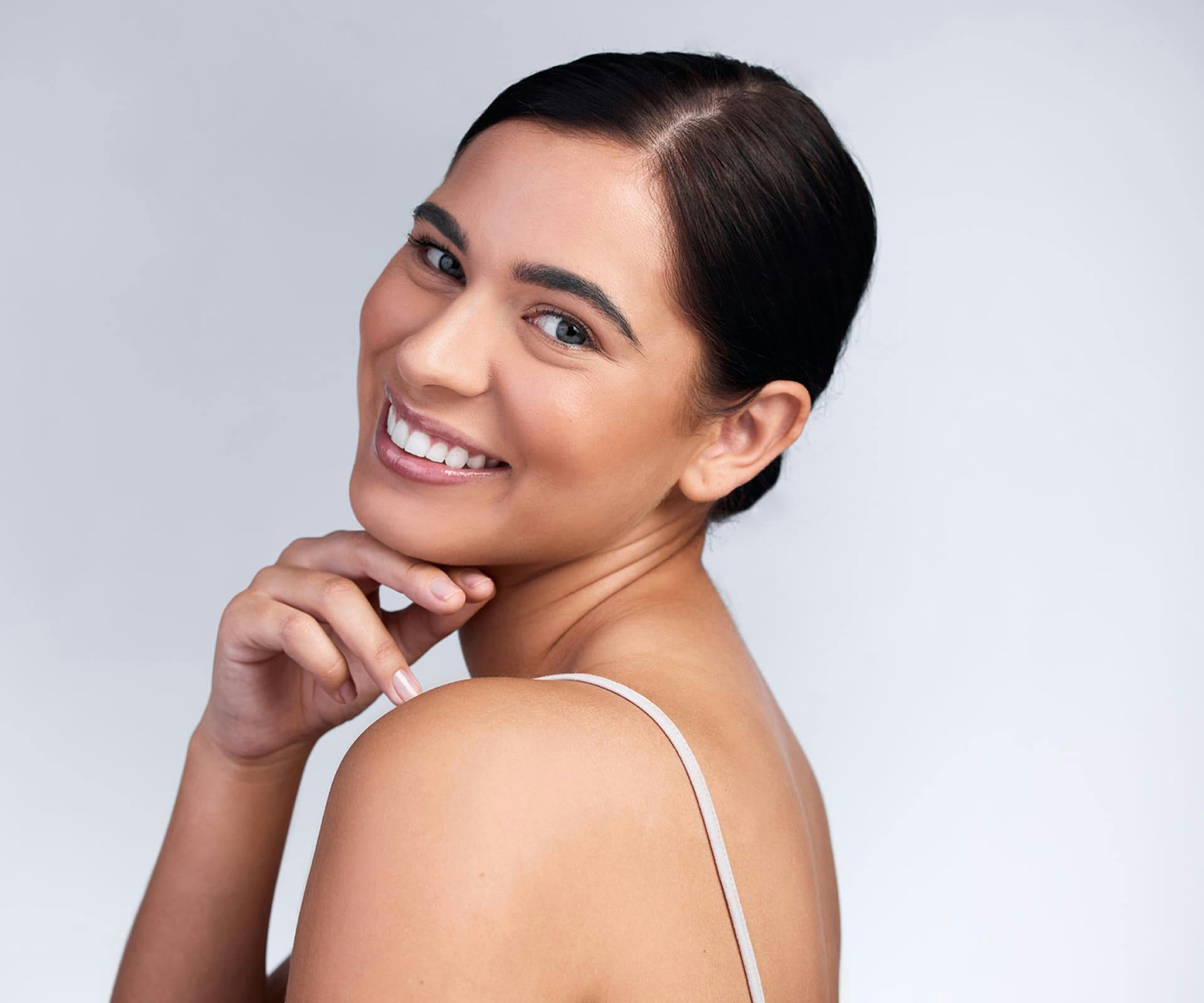 Woman touching chin and smiling