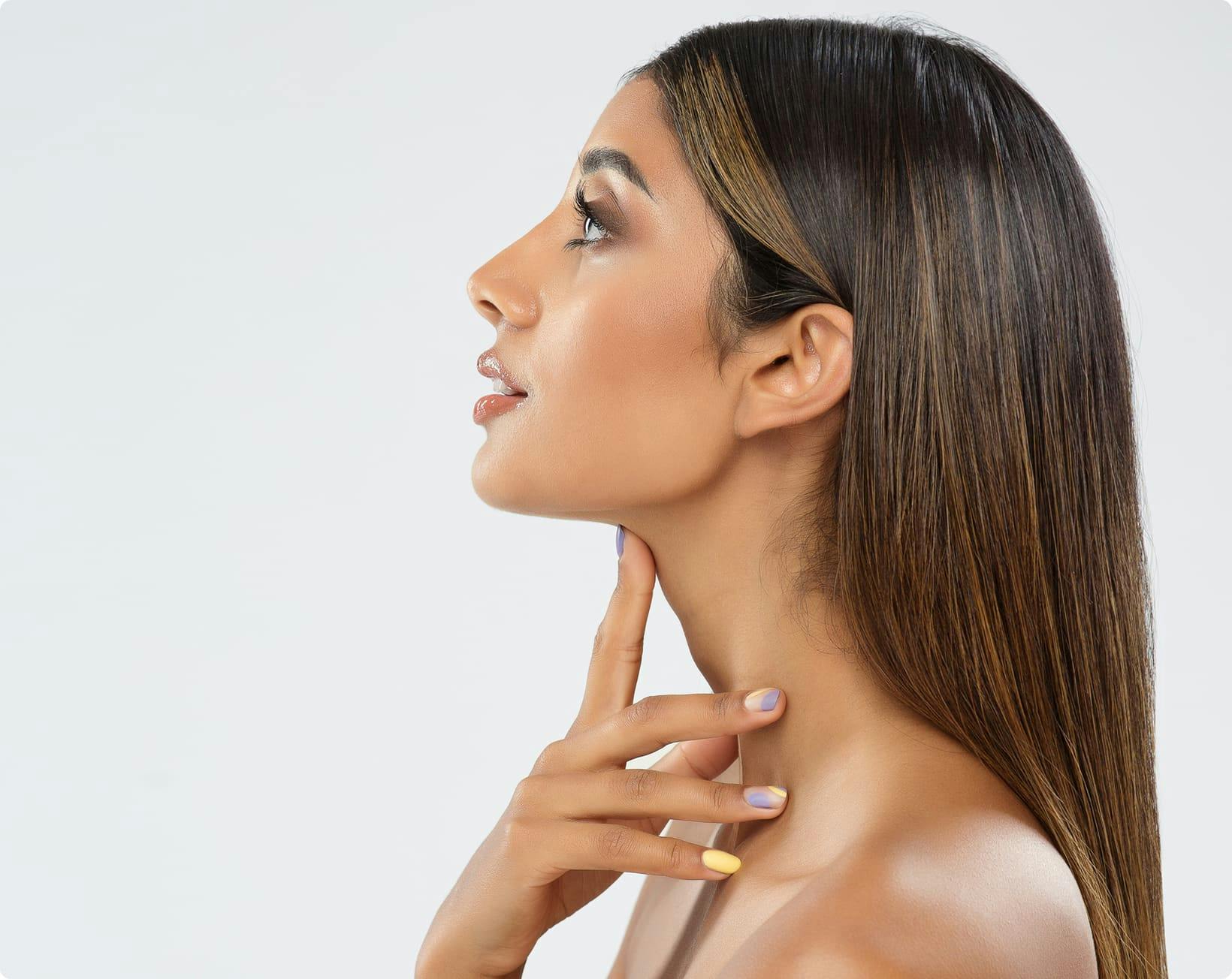 side profile of a woman touching her neck