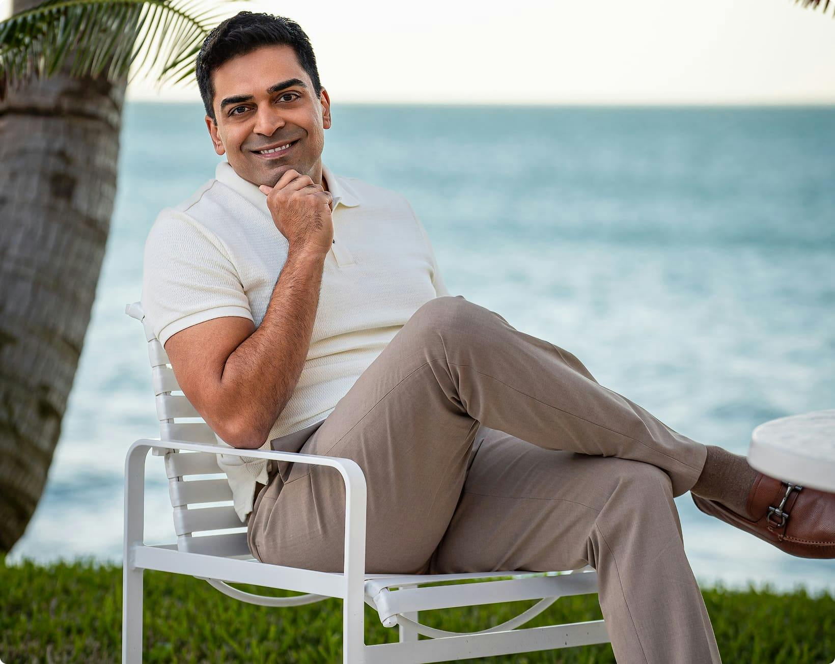 Dr. Nathan sitting in a chair smiling