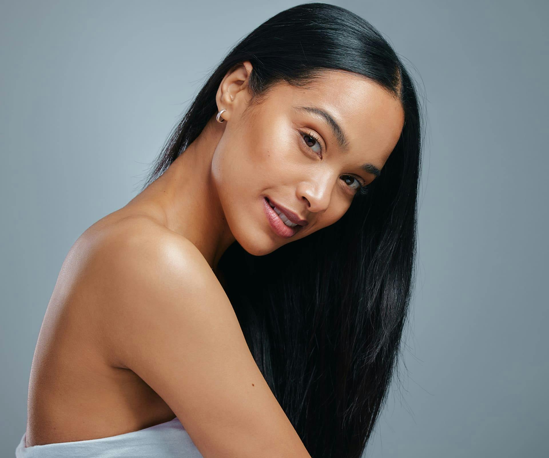 Woman smiling while bending neck