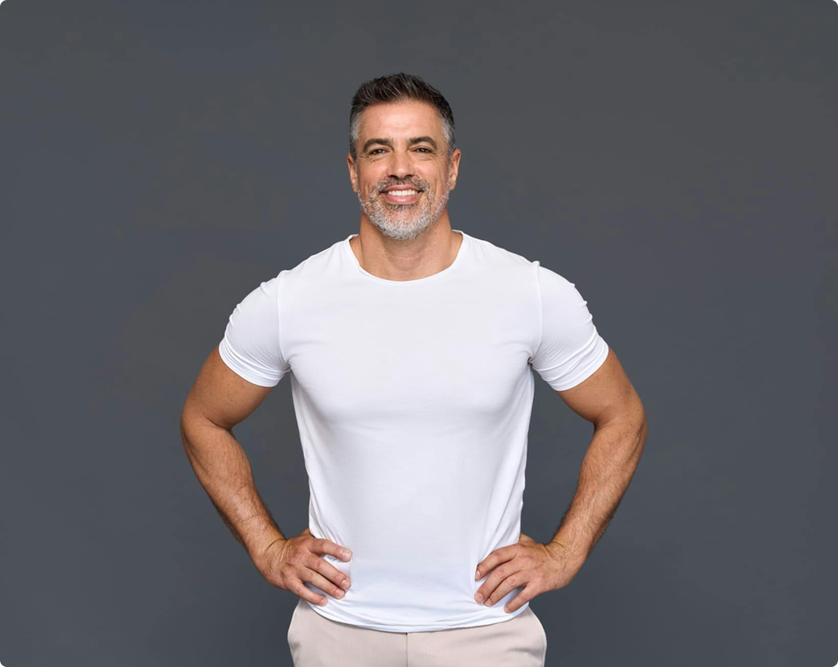 man wearing white t-shirt with his hands on his waist