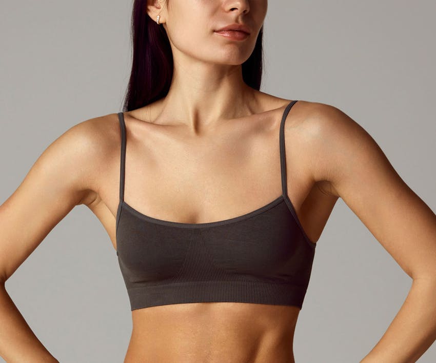 woman with her hands on her hips close up on her breast