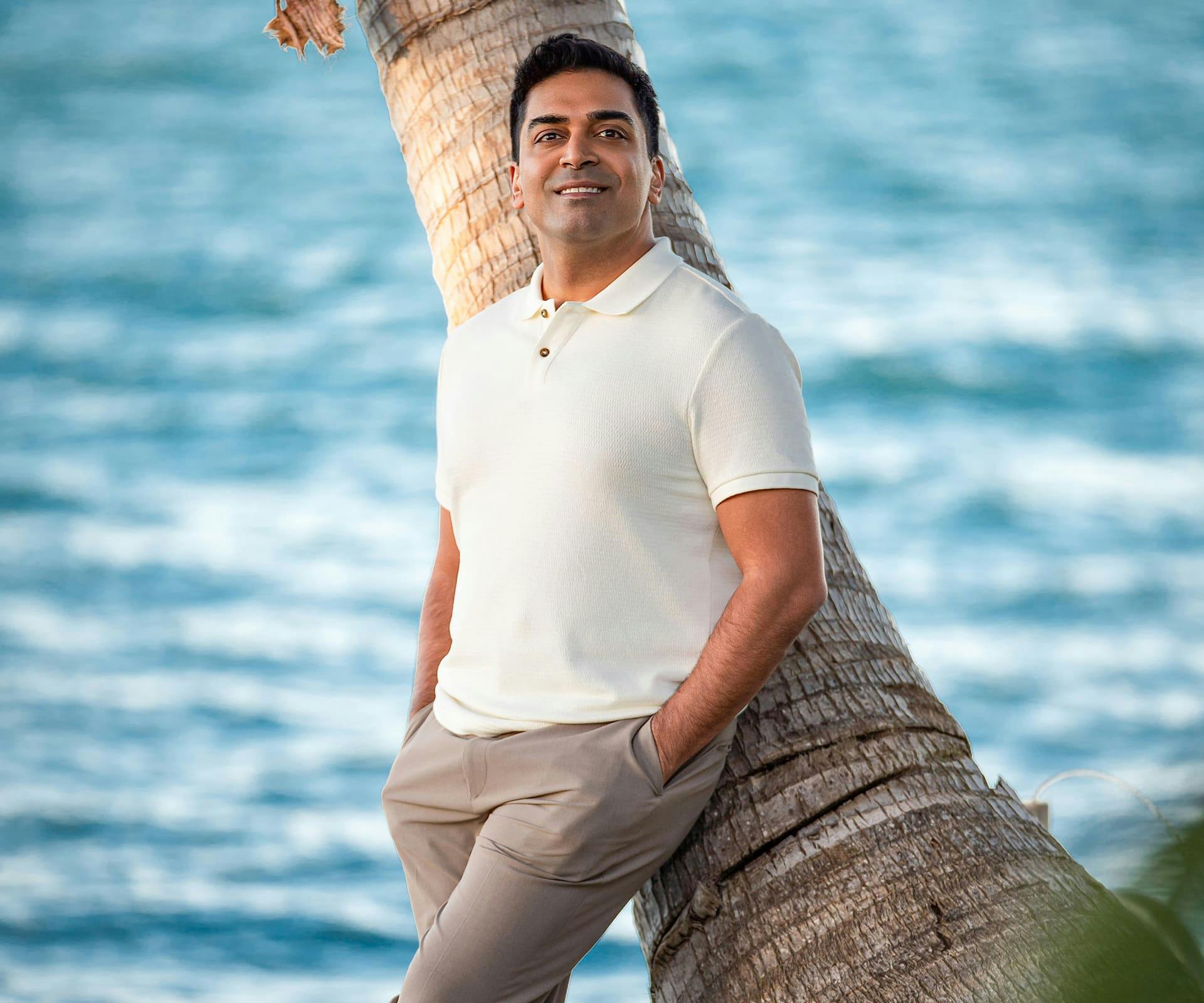 Dr. Nathan leaning on a tree