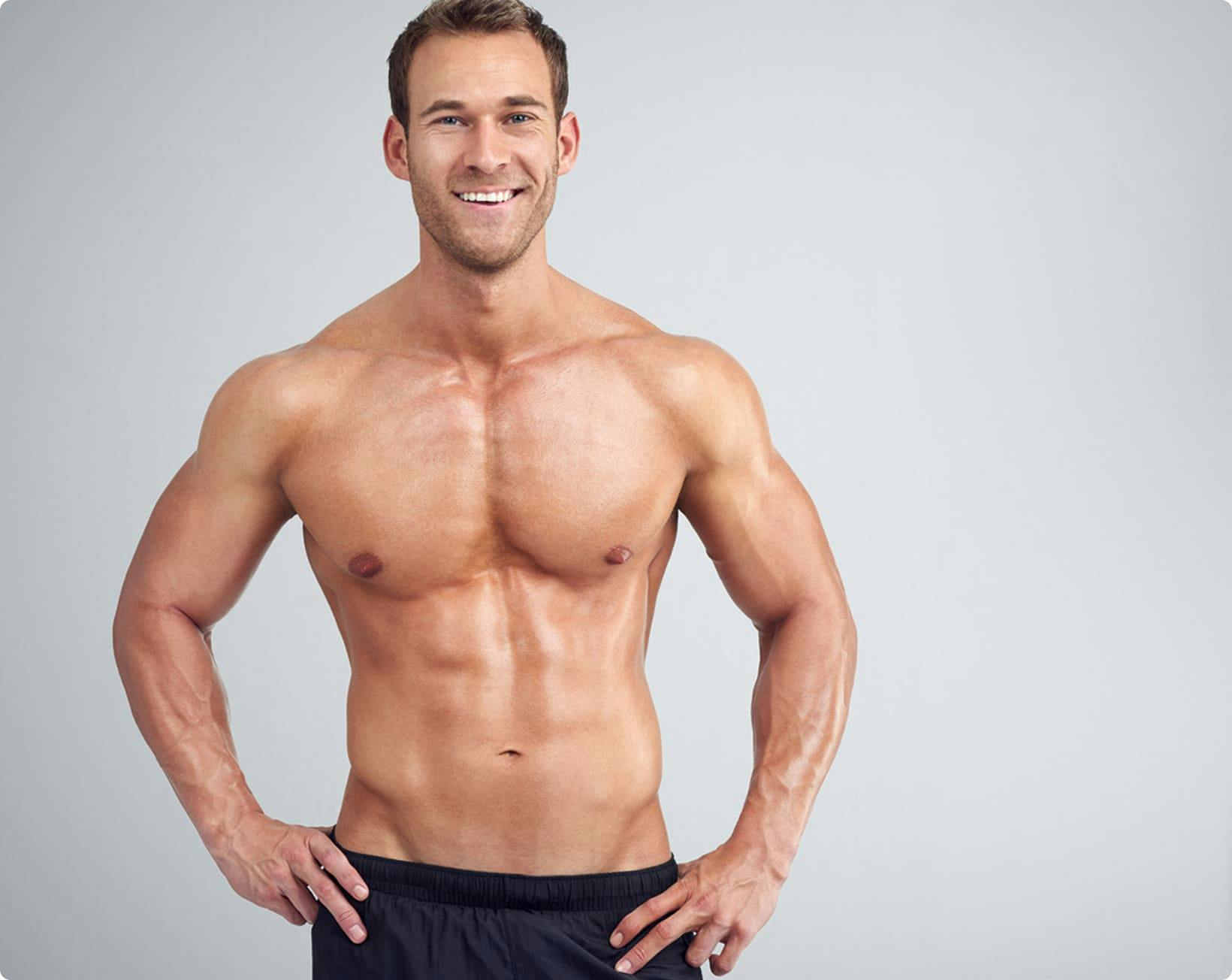 man smiling with his hands on his hips