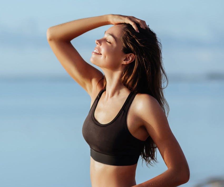 woman brushing her hair out of her face