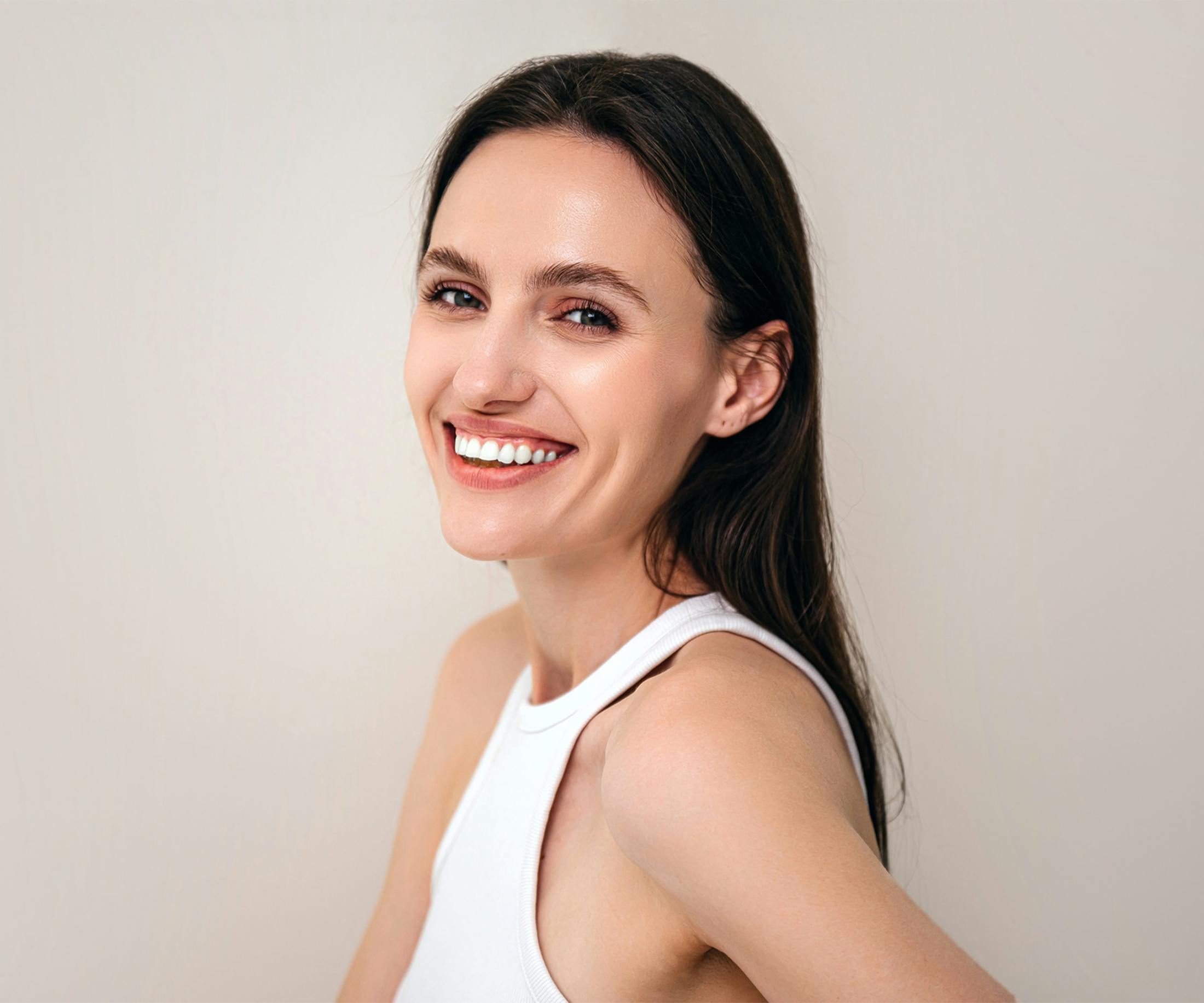woman smiling over her shoulder