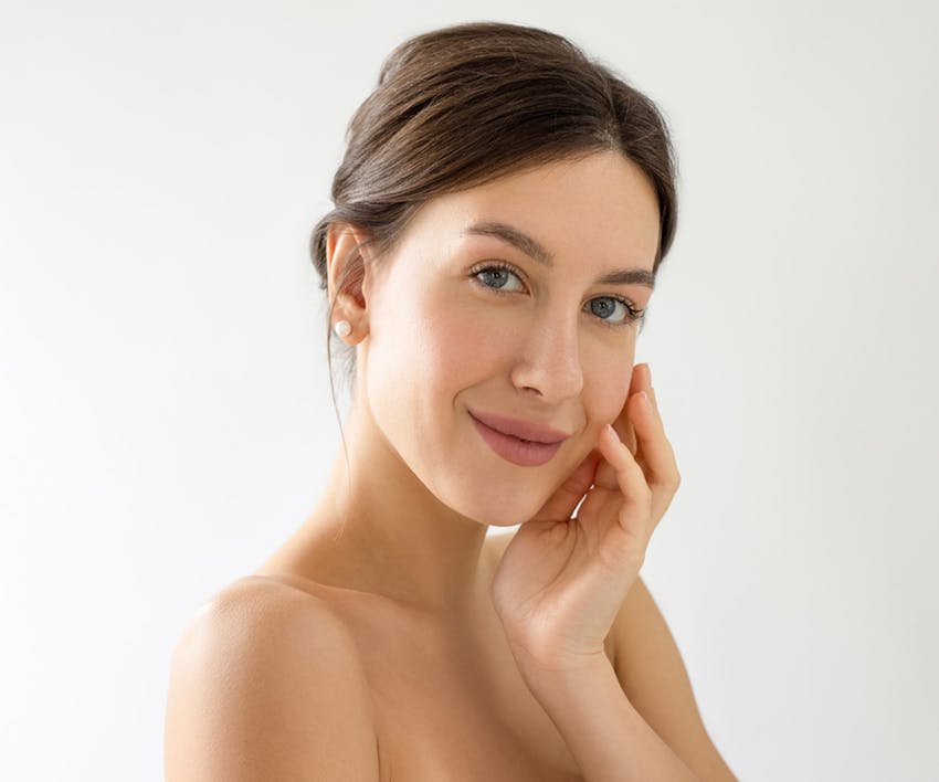 woman touching her face