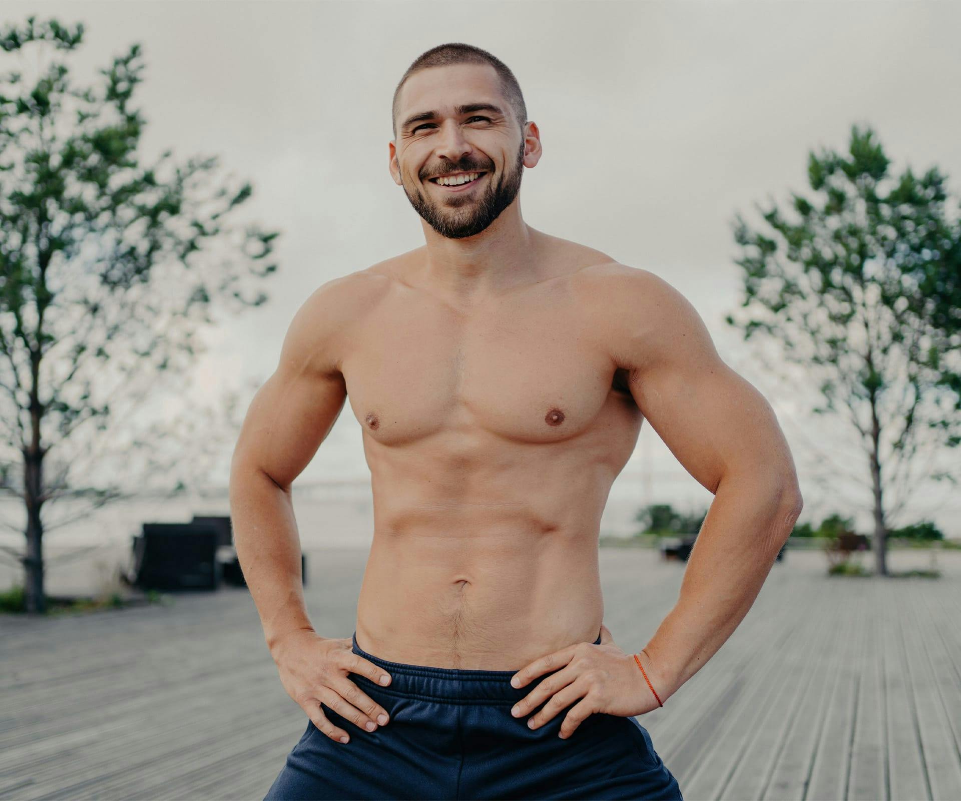 shirtless man with his hands on his hips