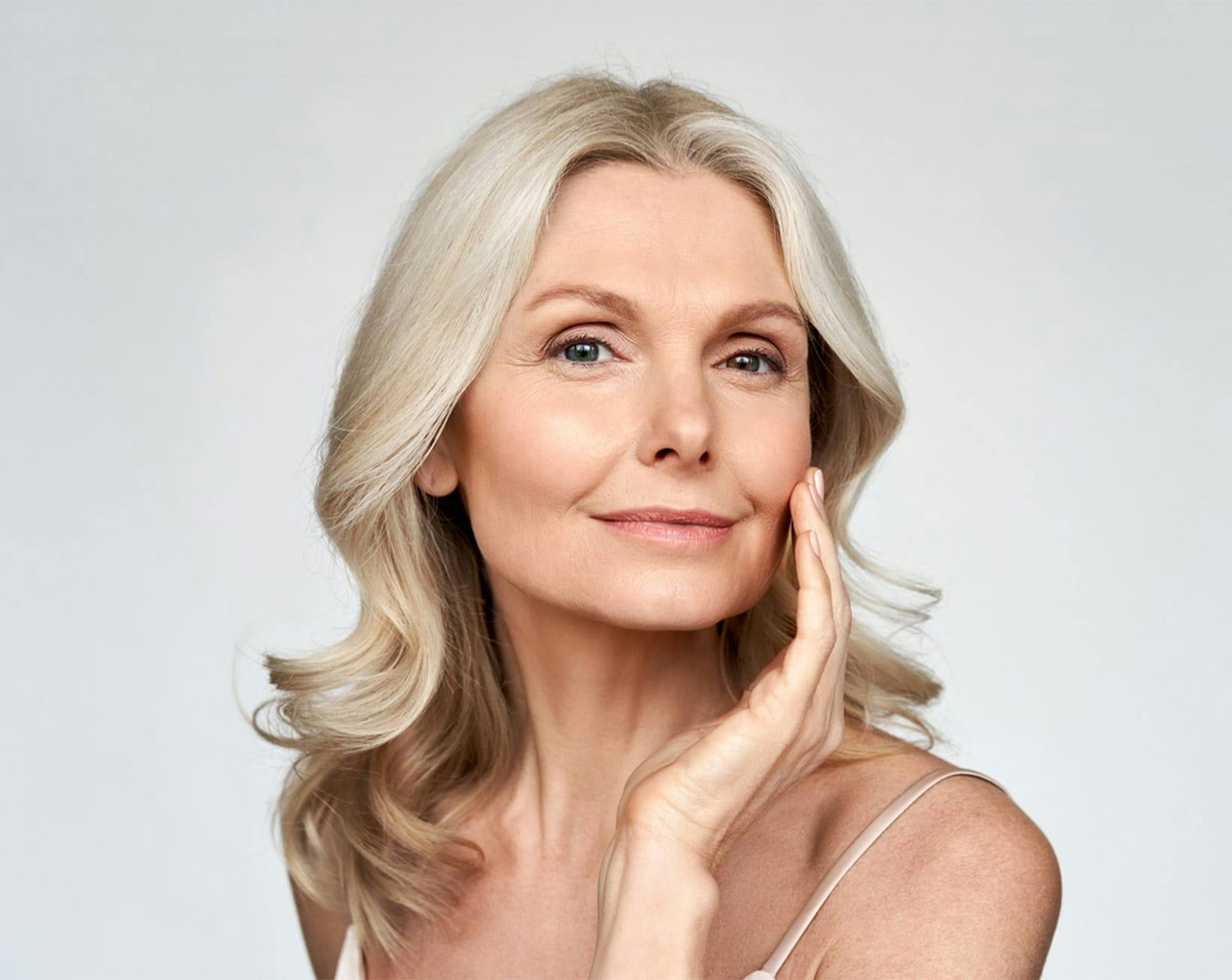 woman touching her cheek