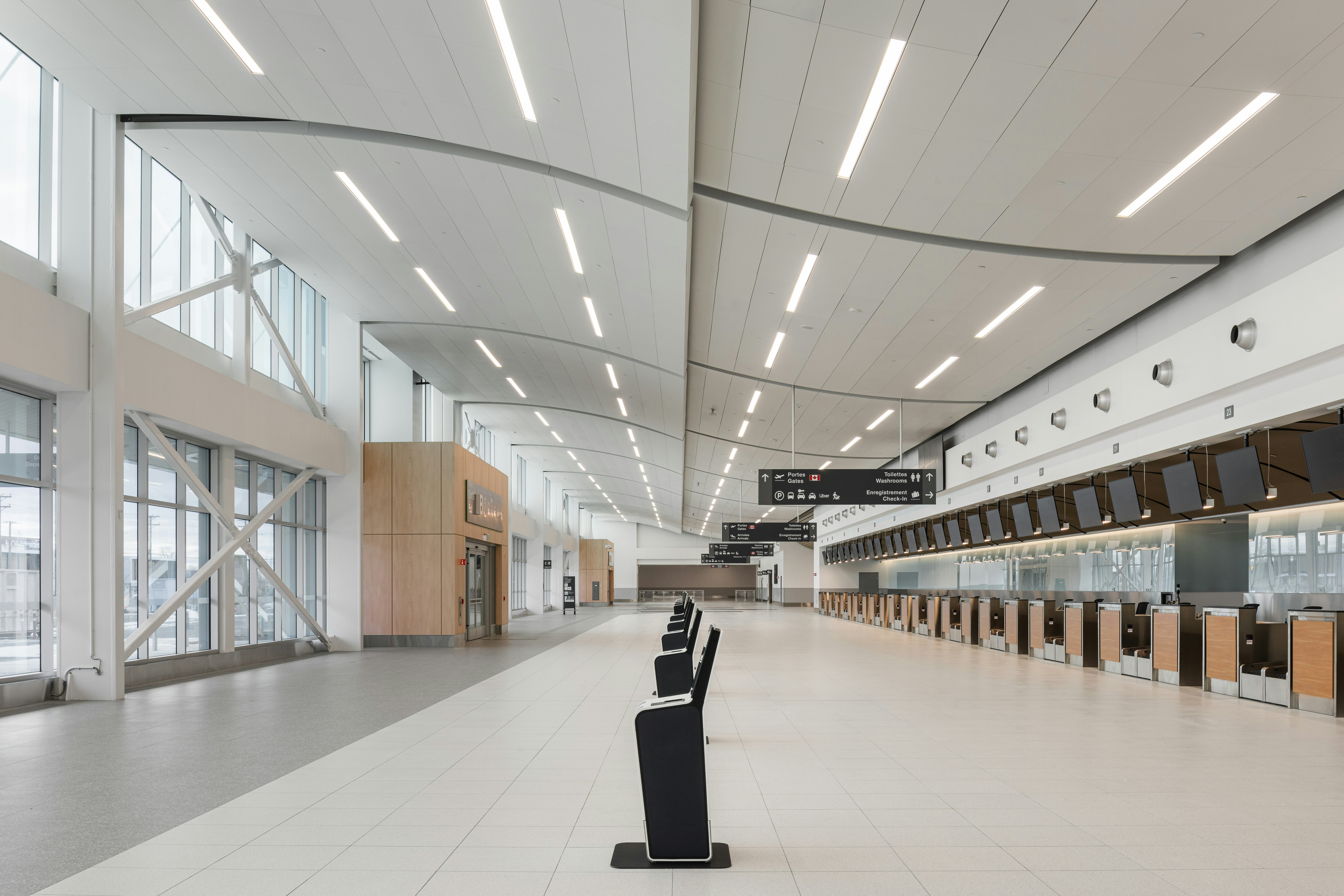 MET terminal check-in hall with counters, overhead signage, and a large illuminated ceiling