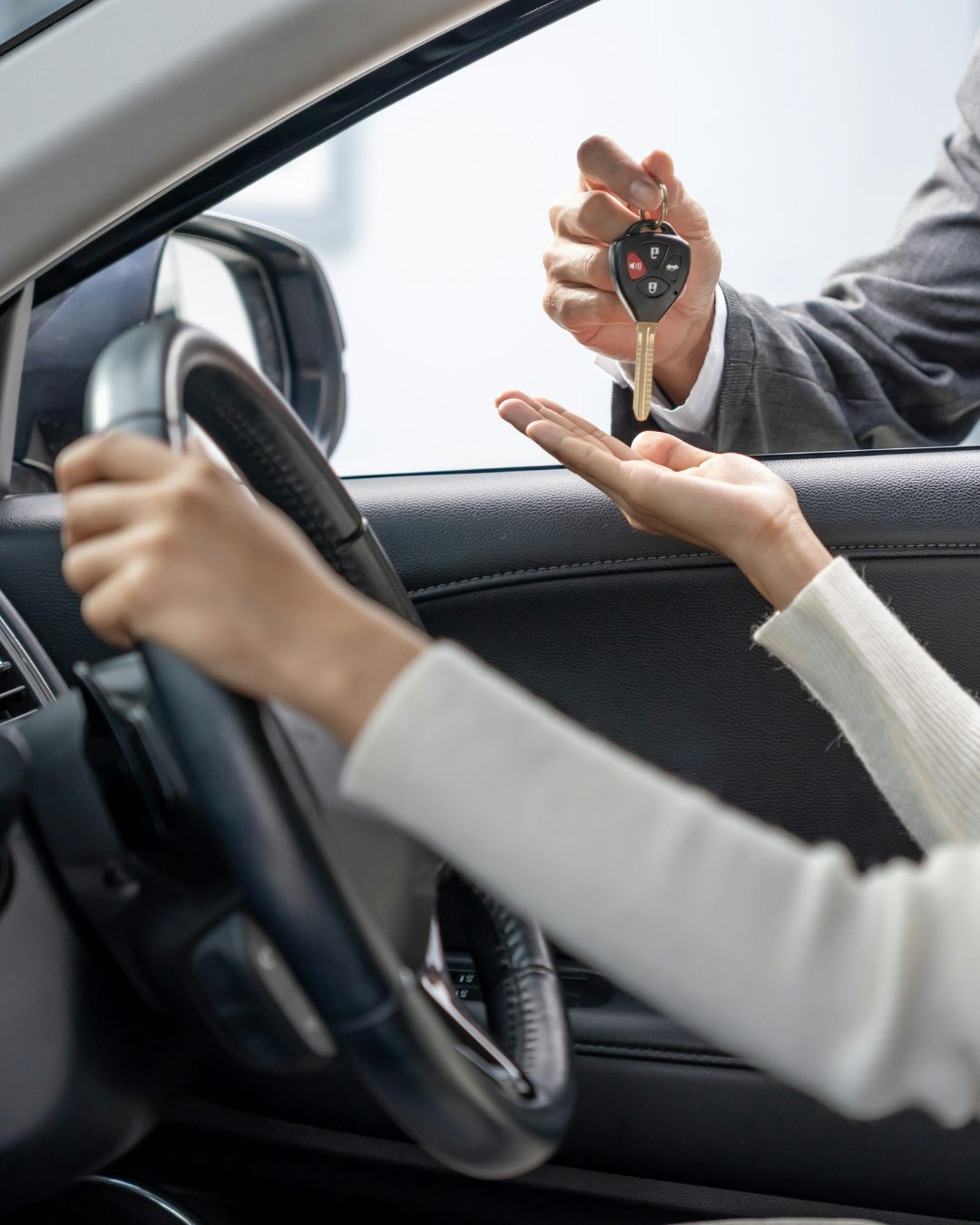 car-rental woman being handed a car key
