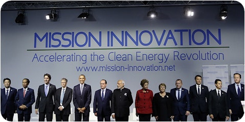 world leaders standing on stage in front of mission innovation banner