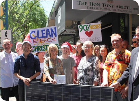 christians holding solar panel and positive solar signs in front of tony abbott's office