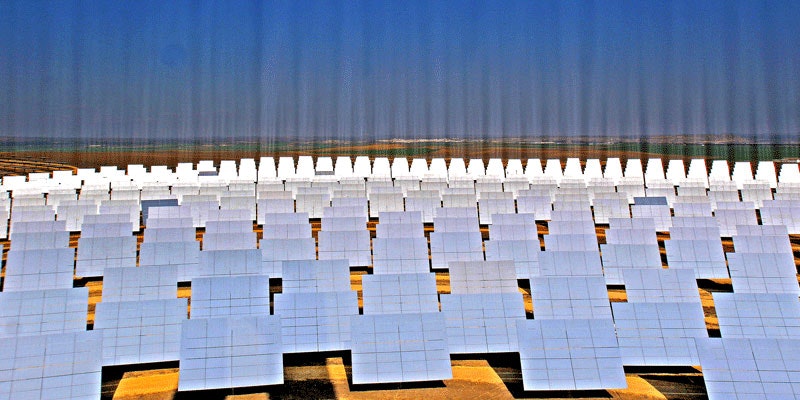 solar farm showing beams of light shining into the sky