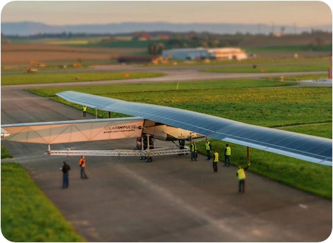 Solar Impulse 2 single-seater solar plane on runway getting checked by aviation officials