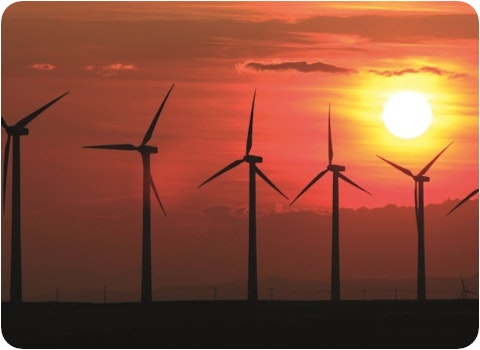 silhouette of 6 wind turbines at sunset