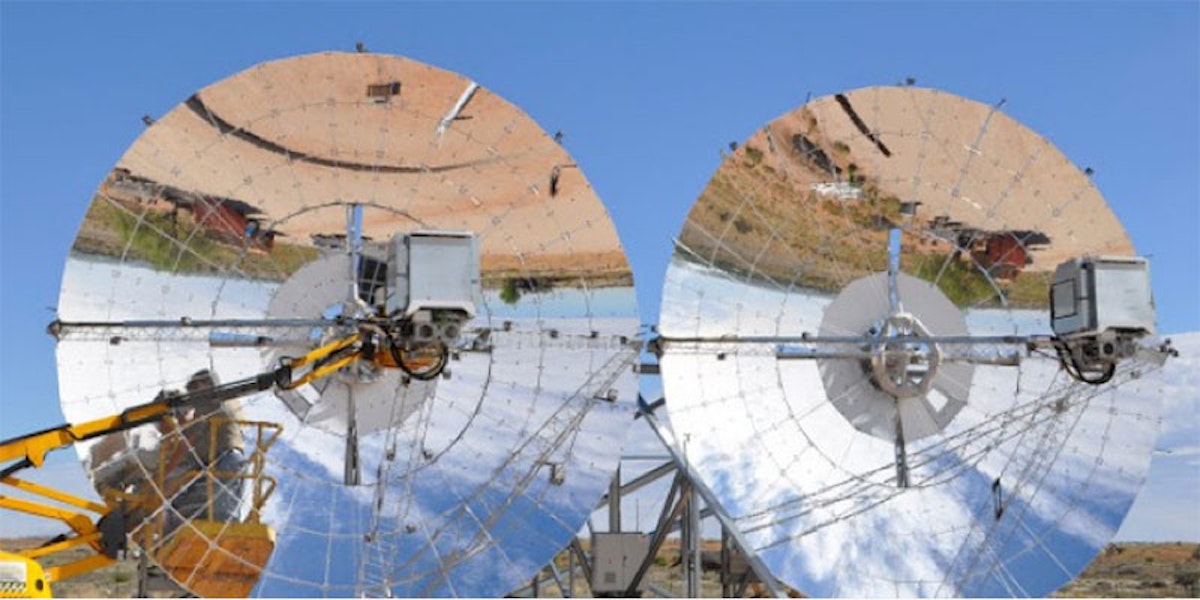 two 12m diameter mirrored ripasso solar energy dishes with blue sky background