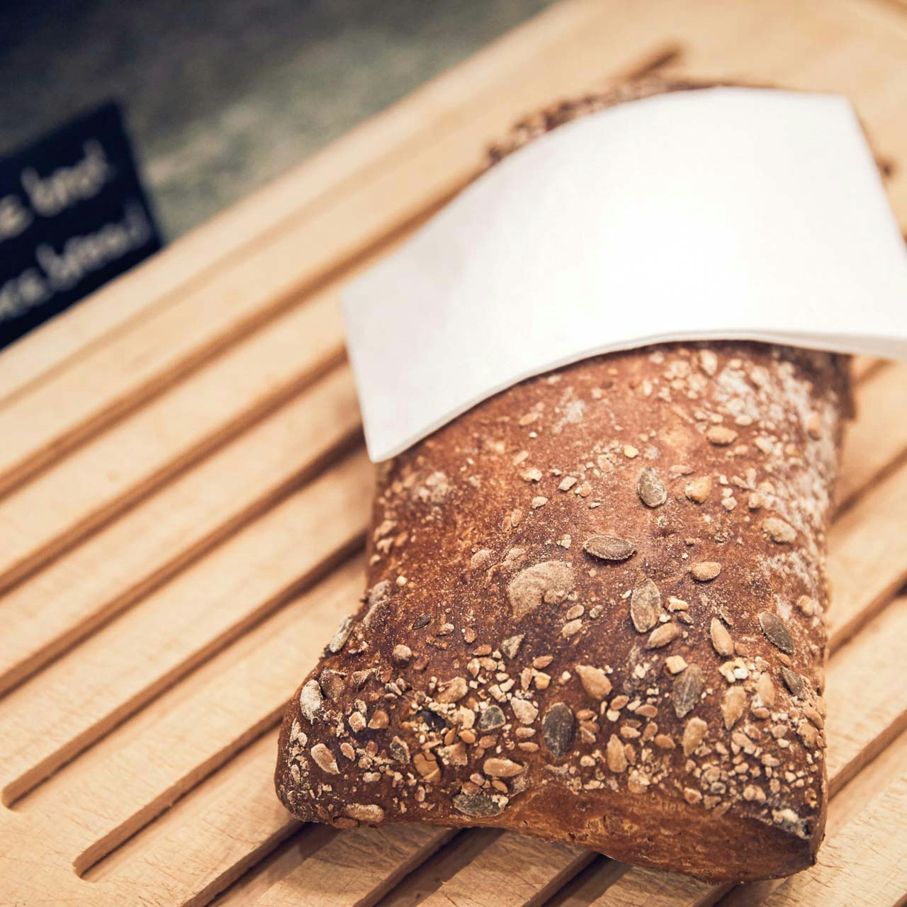 BEATUS Culinary Breakfast Buffet Bread on a wooden board with a white napkin, part of a breakfast buffet