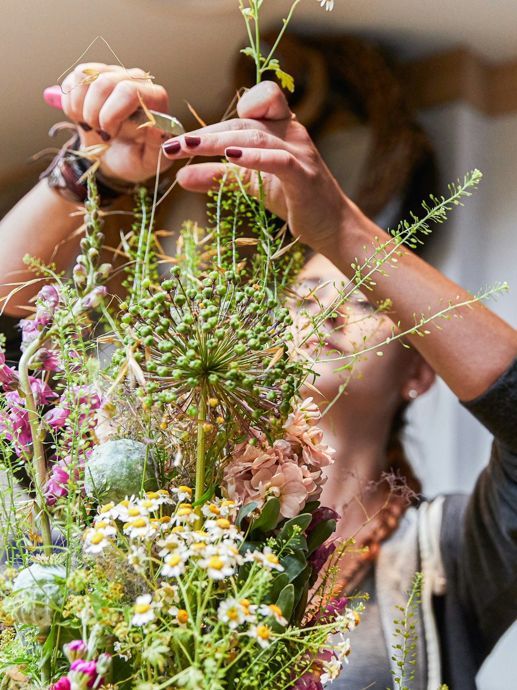 Floristry at the Hotel Ermitage Woman arranges a bouquet of wild flowers