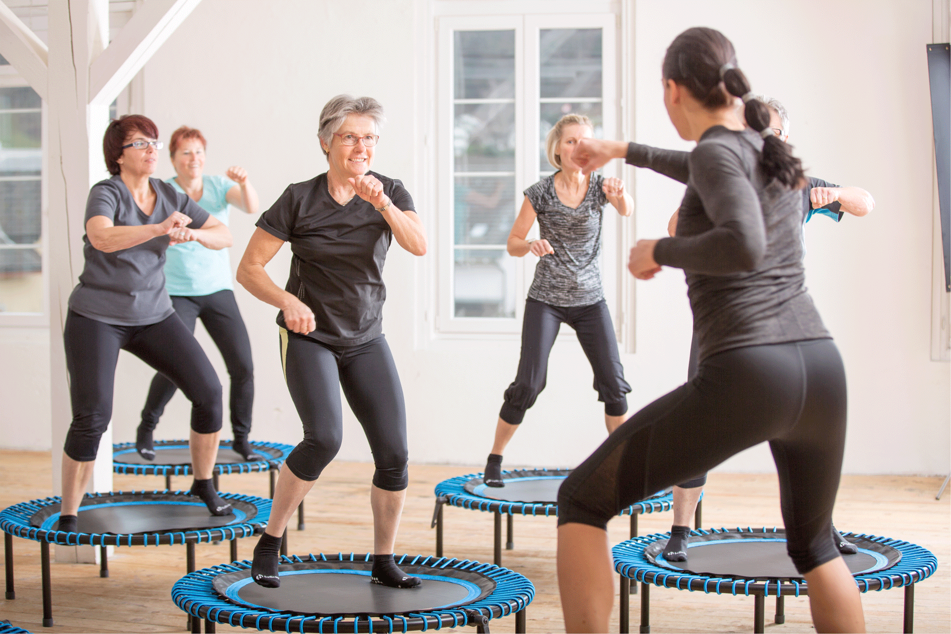 Women doing exercises on a trampoline